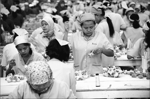 Toy production company, Indonesia. 2003. “Using an hourly wage as the benchmark can help workers [in the Global South] better comprehend how they are being compensated for their work, and it can also help their advocates to better negotiate with the brand-name corporations.” (ILO/Cassidy K.)
