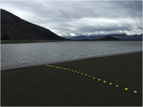 Figure 8. ‘Horizon Drain’ – the edge of Slims River looking toward Kluane Lake. The line of balls sits on the bed of the former river and contrasts with the horizon in the distance. Art image © 2016 K.A. Colorado.