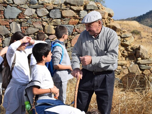 Figure 4. Panagiotis Alexandrou tours Asinou Village with the Grade 5 and 6 classes of the Asinou Regional Primary School. Photograph: author.