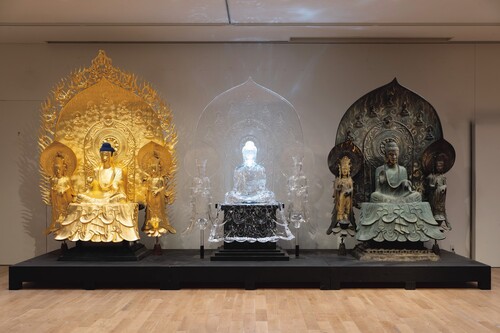 Figure 1. The three cloned versions of the Shaka Triad sculpture on display at the Tokyo University of the Arts, including the golden ‘super clone’ fabrication (left), the transparent ‘hyper’ version (centre), and the precise replica (right). The image used with the permission of the ‘Super Clone Cultural Properties’ research team. ©Tokyo University of the Arts / ©東京藝術大学.