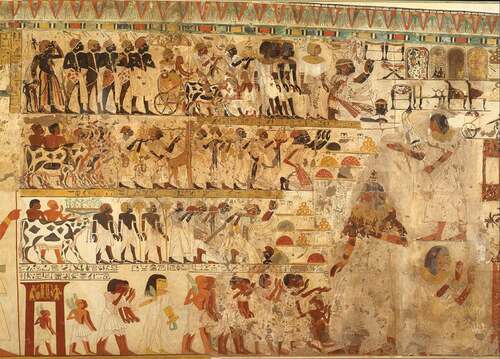 Figure 2. Tribute scene from the Theban tomb of Huy (TT40), viceroy of Kush (Upper Nubia) under Tutankhamun (1336–1327 BCE). In this scene, Nubian elites, including Hekanefer, Prince of Miam/Aniba, were portrayed presenting tribute from Nubia (most importantly, gold) before the honored viceroy of Kush. Facsimile by the Metropolitan Museum of Art. Wikimedia Commons, https://commons.wikimedia.org/wiki/File:Nubian_Tribute_Presented_to_the_King,_Tomb_of_Huy_MET_DT221112.jpg.