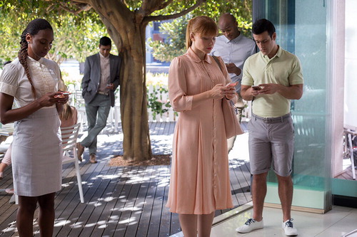 Figure 1. Production still from Nosedive; Lacie Pound (in a pink dress) and others constantly checking their scoring devices (Netflix, n.d.).