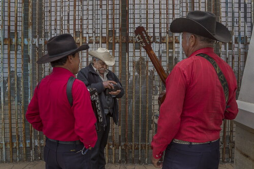 Figure 6. Griselda San Martin, The Wall, 2015–16. José Marquez hires Mexican norteño musicians to sing a song to his daughter Susana, 33, and grandson Johnny, 14, who live in California and meet with him every month at the border wall. They have not been together in 14 years since Marquez was deported. Photograph © Griselda San Martin.