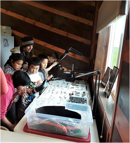 Figure 8. Small visitors studying arefacts in the Culture Center on the day of the opening. Picture by Rick Knecht.