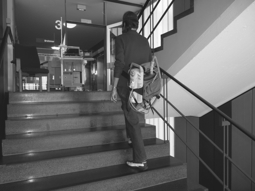 Figure 1.  A COPD patient using CPAP in addition to supplemental oxygen during stair climbing. The oxygen tank and CPAP device are transported in a commercially available hip belt.