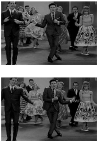 Figure 1 From two consecutive scenes in the movie, Hairspray. Note widening of the distance between two hands, as the artist (in the center) moves his hands simultaneously to the right. This is related to the invasion of the midline by the right arm seen in the scene below, indicating larger excursion by the dominant side. On the other hand respect for the midline by the nondominant hand is noted in the scene above. The larger excursion by the dominant hand means its faster speed as the hands move simultaneously from side to side. See text for further explanation.