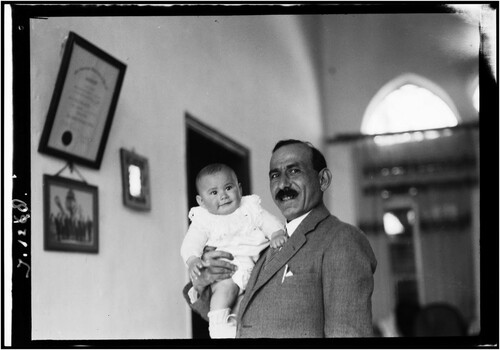 Figure 10. Issa al-Issa holding his son Raja in his house in Jaffa, UBL_NINO_F_Scholten_Porte_Entree_101-150_0011].