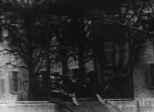 Figure 2 Patients knocking down the fences around the hospital, Gorizia. Source: Giorgio Osbat, used uncredited in I giardini di Abele (Citation1969a). Rai-Teche.