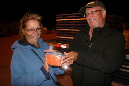 Figure 2. Harry Jones and Jocelyne Roy with bakeapples for Dad. 7 August 2014. Photo by the author.