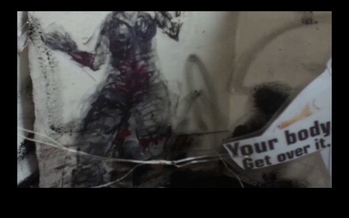 Figure 3. Still frame depicting a drawing of a figure seated in a wheelchair placed beside the words, ‘Your body. Get over it’. From slide/cascade by Elaine Stewart.