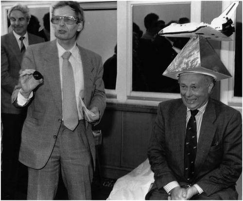 Figure 5. Honoring Gottfried Konecny in 1990 for his Metric Camera activities with a typical Hannover “Doctor Hat” and joking about small things which had not been optimal