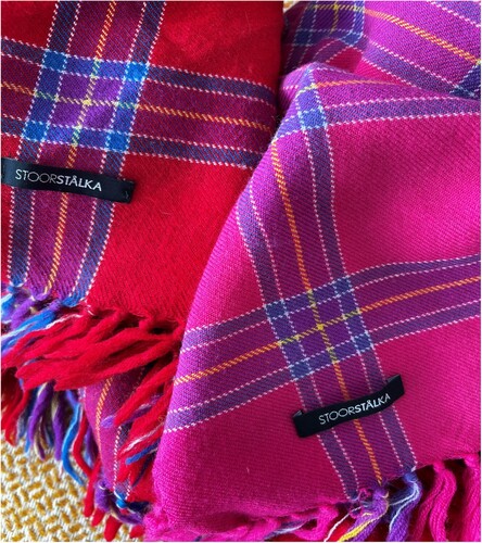 Figure 4. One of the examples of modern accessories using traditional inspiration from Stoorstålka, a Jokkmokk (Sweden) based company. A photograph showing two examples of modern woollen scarfs beside each other, inspired by traditional Sámi dresses and produced by the Stoorstaelka company which is based in the town of Jokkmokk in Sweden. (Source: author’s own).