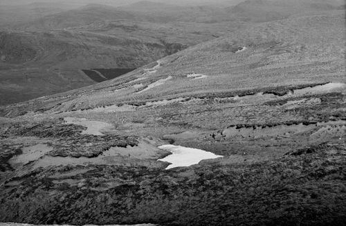 Figure 27 Eroded vegetation-covered sand sheets at the margin of the northern plateau of An Teallach, Wester Ross. The sand at the plateau margin reaches depths of up to 4 m