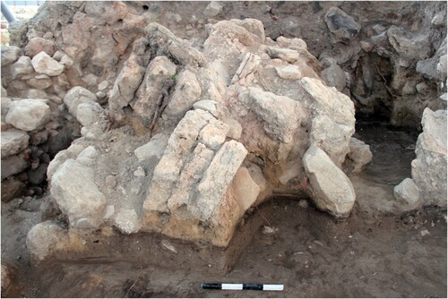 Figure 3 A typical accumulation of the destruction debris of Stratum VIA. The black line at the bottom of the debris signifies the floor; Square I/2 in Area Q, looking north (courtesy of the Megiddo Expedition).