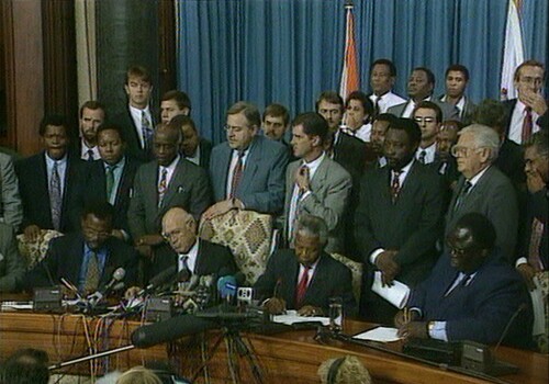 Figure 1. The 19 April 1994 signing of the memorandum of agreement (left to right: Buthelezi, De Klerk, Mandela, Okumu) (used with permission; Associated Press LIC-01418921)