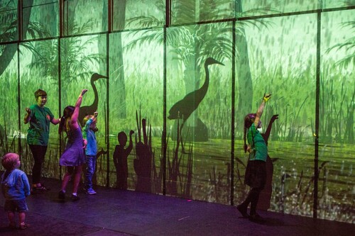 Figure 1. Children interacting with interactive environment featuring Australian flora and fauna.