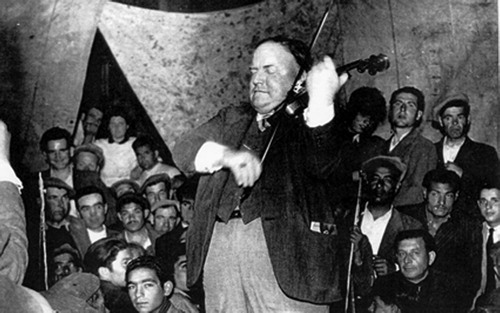 Figure 1 Walter Starkie plays the violin in a Gypsy tent.Photo reproduced courtesy of Mr John Murray.