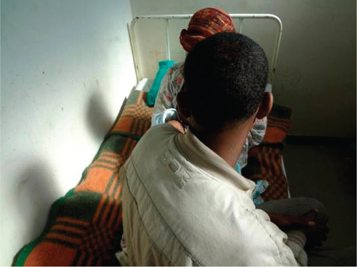 Fig. 1 A picture of the couple with their 3-week-old baby boy in a psychiatric hospital bed in Addis Ababa. Photo by Abebaw Fekadu.