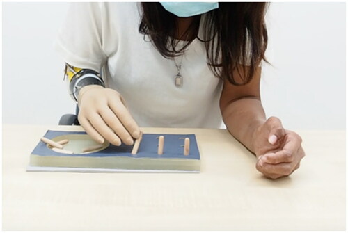 Figure 3. Image of a participant performing the Nine-Hole Peg Test with IPJ-Hand.