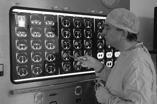 Figure 1. Surgeon interrogating the 2D images using a light box.