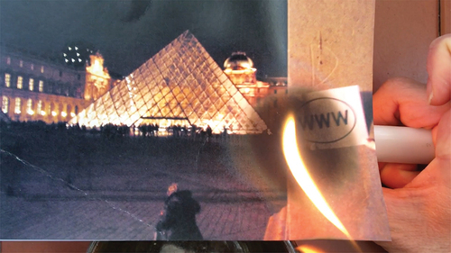 Fig. 6. A frame from the video of Julia Mortimer burning the image she received of the Louvre’s pyramid.