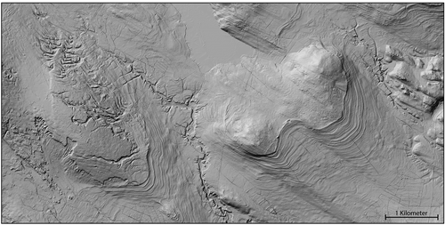 Fig. 4. LiDAR image covering an area N of Boliden northern Sweden with the highest coastline clearly visible with beach ridges in lower terrain and glacially lineated till at higher terrain. In the western part a landslide in till and lateral meltwater channels have been eroded by wave action. In the valley bottoms ravines are visible. Illumination from NW.