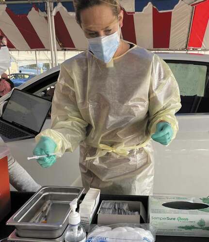 Figure 1. Board certified orthodontist Dr Amy Gimlen prepares to give COVID19 immunizations at a county vaccination centre in April 2021. The pandemic reminded orthodontists that they are part of the health team