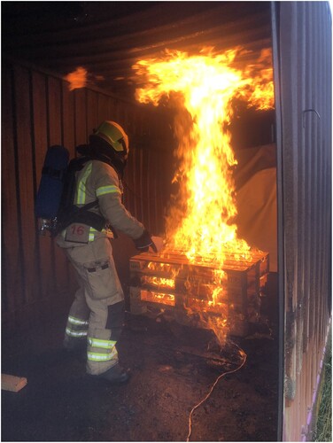 Figure 5. Igniting the stacked pallets for fire test.