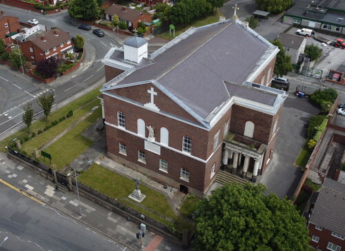 FIG. 2 Drone view of St Patrick’s churchyard church, with its impressive Western façade and the door to the crypt visible at ground level (photo by R. Philpott).