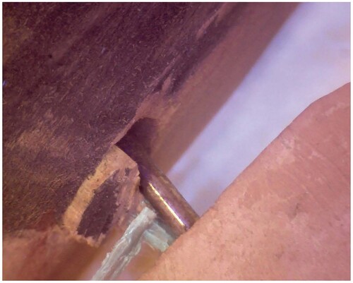 Figure 13. Metal rod replacing sawn off wood dowel observed on proper left side appendage on 101594 (Figure 4). Photo credit Ellen Pearlstein.