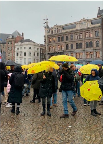 Figure 3. These yellow umbrellas, decorated with hearts and slogans like ‘love’, ‘freedom’, ‘connection’ and ‘truth’ have become a key symbol at protests. Photographed by first author at the Dam square in Amsterdam, 6 November 2022.