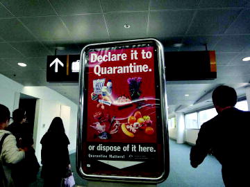Figure 1. Example of a ‘not to be missed’ warning billboard. Upon arrival in one of the international airports of Australia, one is confronted with, among others, this billboard. The text indicates the products that are forbidden from being imported. The traveller can dispose of such products in special bins located under the billboard (photograph courtesy H. Surborg).