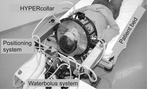 Figure 1. Picture of the HYPERcollar applicator system. Both patient bed and positioning system (neck support) are used to position the patient. The coaxial cables, that are normally connected to the applicator, are not shown for visibility.