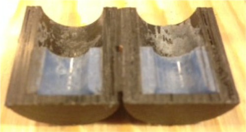Figure 5 Measurement of the cement height by cutting cement holding cup into half using the band saw machine.