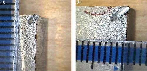 Figure 5. Photographs of the two crudely made corner notches with notch 2 (b) being slightly longer than notch 1 (a). The intervals on the ruler placed in the images are 1 mm apart.