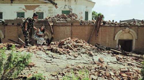 Figure 5. A soldier approaches a girl who has just recovered a family photograph from the ruins of her family home.  From video of Dinesh DC’s “Dhale Dharohar”.