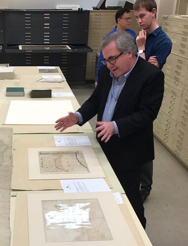 Ed Redmond, leading a tour of the Library of Congress, Geography and Map Division Vault, enthusiastically describes two maps drawn by George Washington.