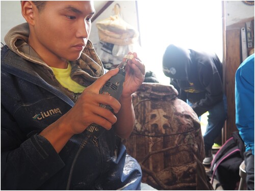 Figure 2. Christian Alexie Jr intensely concentrating on the task at the Ivory carving workshop. Picture by Carl Nicholai and Crystal Carter, used with permission.