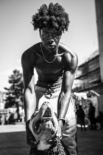 ‘I came to the UK a year ago from Monserrate, a small island in the Caribbean. I walk my friend’s dog Cabanna and get to chat to people in the square. I used to look after dogs back home so this gives me a sense of belonging.’ Joshua. Photo by Don Travis.