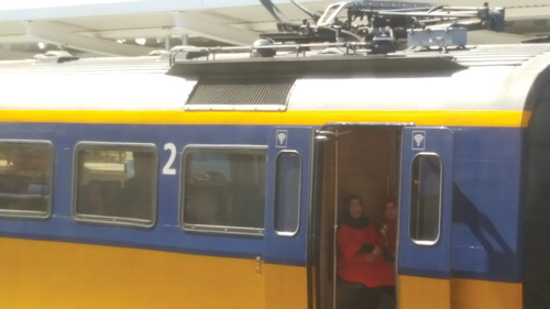 Figure 1. Two veiled women sitting and waiting in between train compartments. Photo by author.
