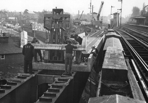 FIGURE 11. Bushey Bridge, with forklift placing precast units to form composite steel girders, 1963, whilst tracks are interlaced. Author’s collection