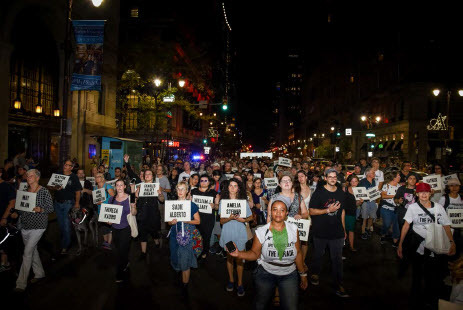 Figure 1. Blast Theory, SPIT SPREADS DEATH: THE PARADE (2019). Participants walking, holding signs with the names of Philadelphia residents who died in the 1918 Spanish flu epidemic. Photo Tivern Turnbull