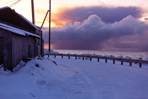 Figure 1. The Calm Before the Storm. © Dennis Davis, all rights reserved. “This is a winter snow storm. All the water that’s there on the ocean, it is supposed to be frozen, but it’s not and you have a big storm coming. This is beautiful, but it is also dangerous. This was in October – right at the beginning of the storm season; if the ocean is frozen, then the waves can’t cut into the permafrost and cause erosion and flooding. If the water is not frozen, then it is dangerous.”