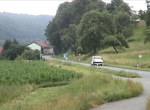 Figure 1. Screenshot of an Endpoint-oriented motion event: a car driving on a road towards a village/houses.