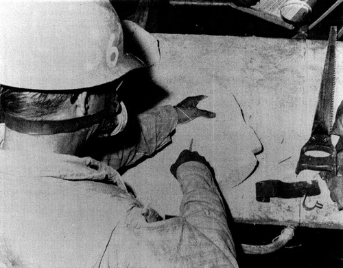 Figure 6.  Insulator shaping a piece of insulation at Puget Sound Naval Shipyard. Photo source: Carl Mangold. Previously published in Hollins et al., Citation2009.