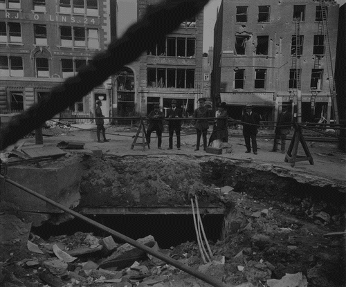FIGURE 1 Bomb crater in Bartholomew Close, 8 September 1915. Reproduced permission of London Metropolitan Archives, City of London SC/GL/PHO/C/075/5 (Collage 37000).