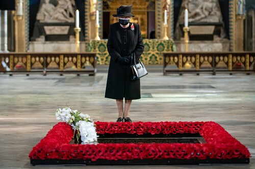 Figure 1 Queen Elizabeth inspects a bouquet of flowers placed on her behalf at the grave of the Unknown Warrior by her Equerry, Lieutenant Colonel Nana Kofi Twumasi-Ankrah, during a ceremony in London’s Westminster Abbey to mark the centenary of the burial of the Unknown Warrior, in Britain November 4, 2020.(Alamy Image/ © Aaron Chown/Pool via REUTERS)