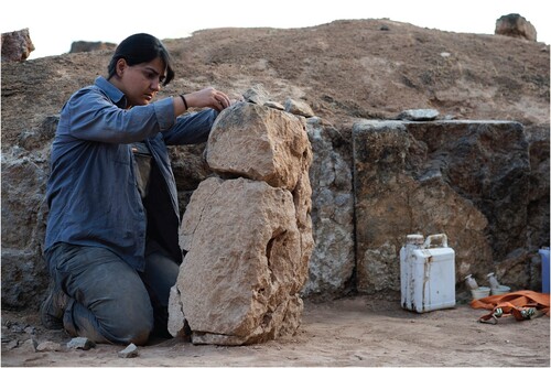 Figure 7. Restoration of the broken limestone orthostats of the MBA palace by conservator Hatice Nur Aydın (Level VII).