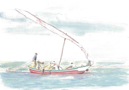 Tanzanian fishermen in a sailing boat paying out a fishing net into the water