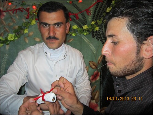 Figure 3. Putting henna on the little finger of the groom's right hand (Adnan Almohamad, 19 January 2013).